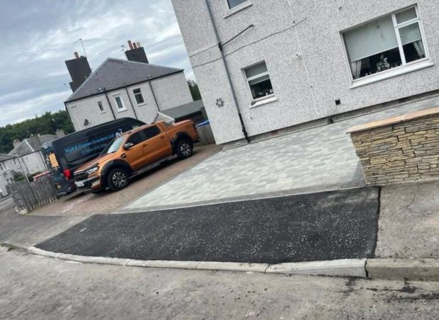 Tarmac crossing running from a driveway down to the lowered kerb at the road