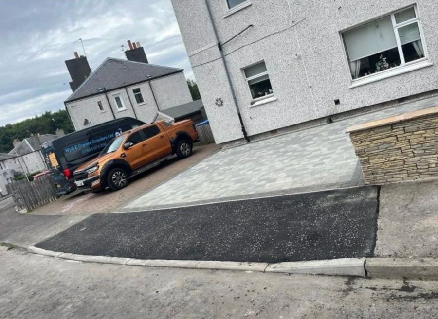 Tarmac driveway crossing run out to meet the road